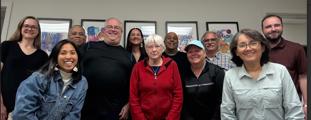 A group of people are posing for a picture in a room.
