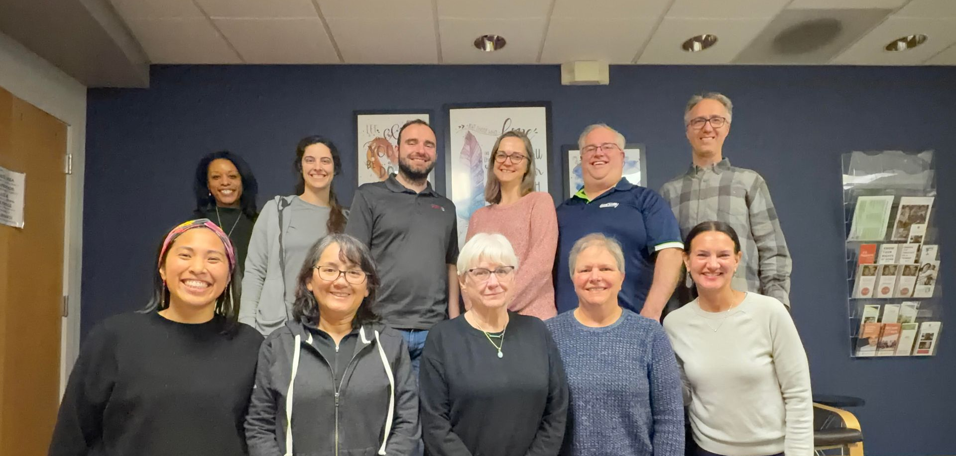A group of people are posing for a picture in a room.