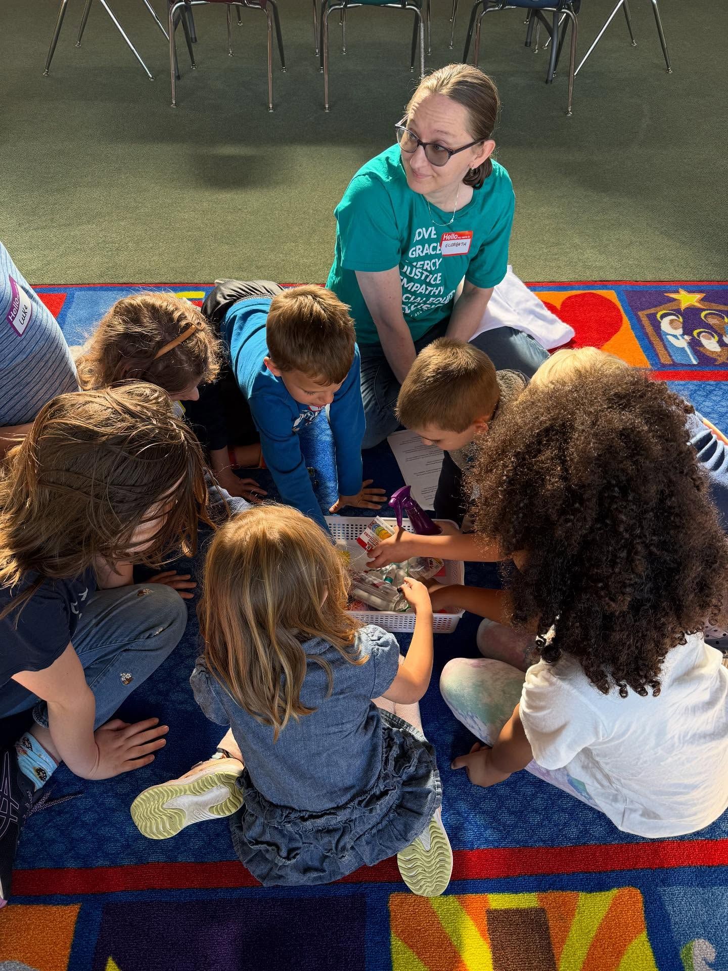 A group of children are sitting on the floor in a church.