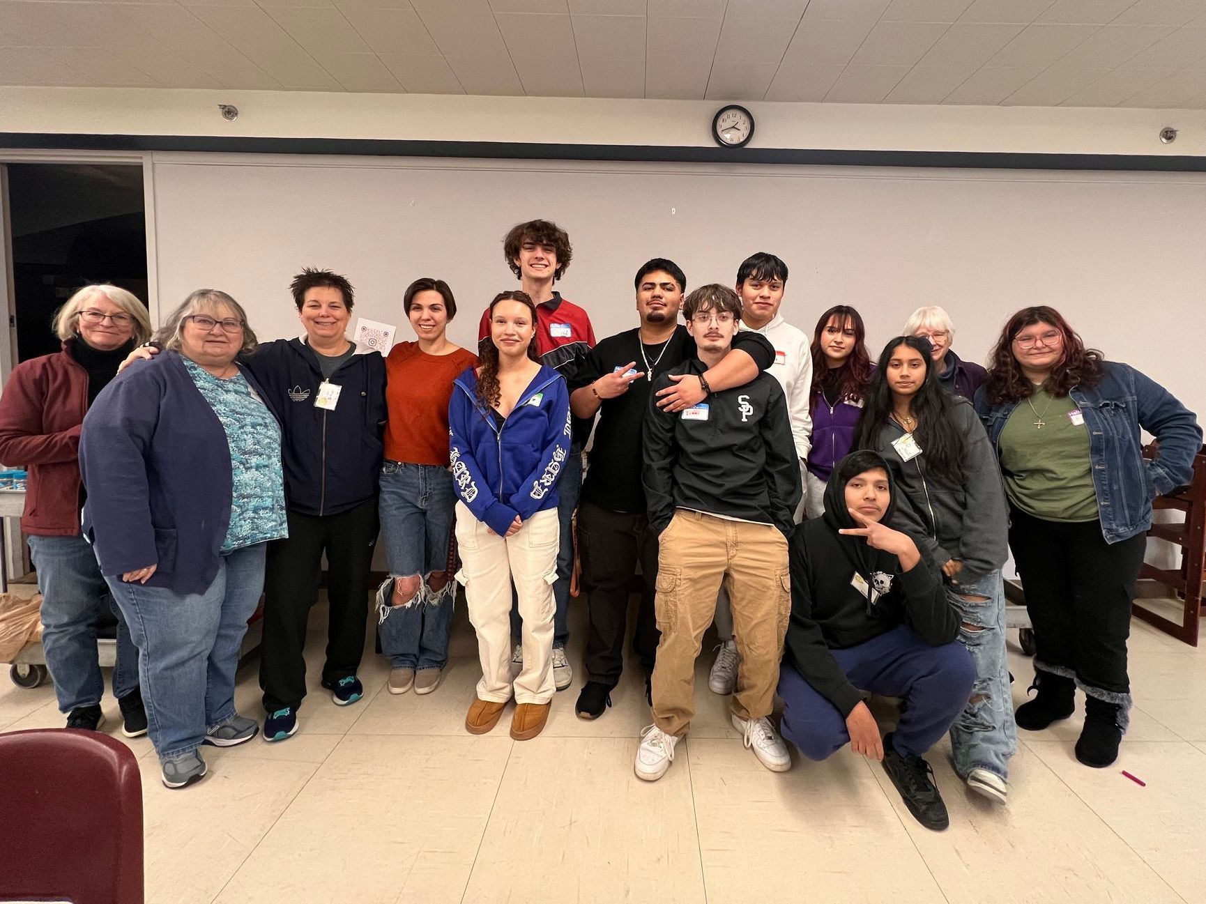 A group of people are posing for a picture in a room.