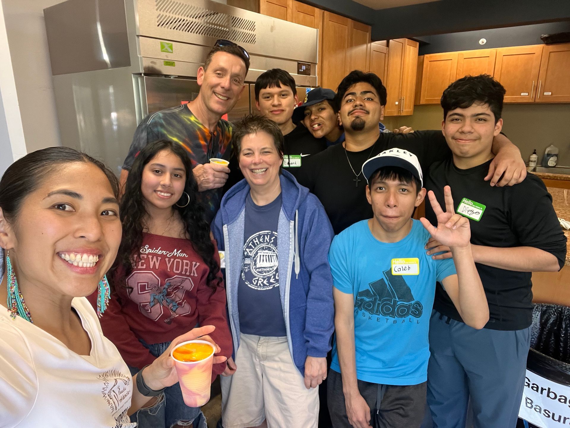 A group of people are posing for a picture in a kitchen.