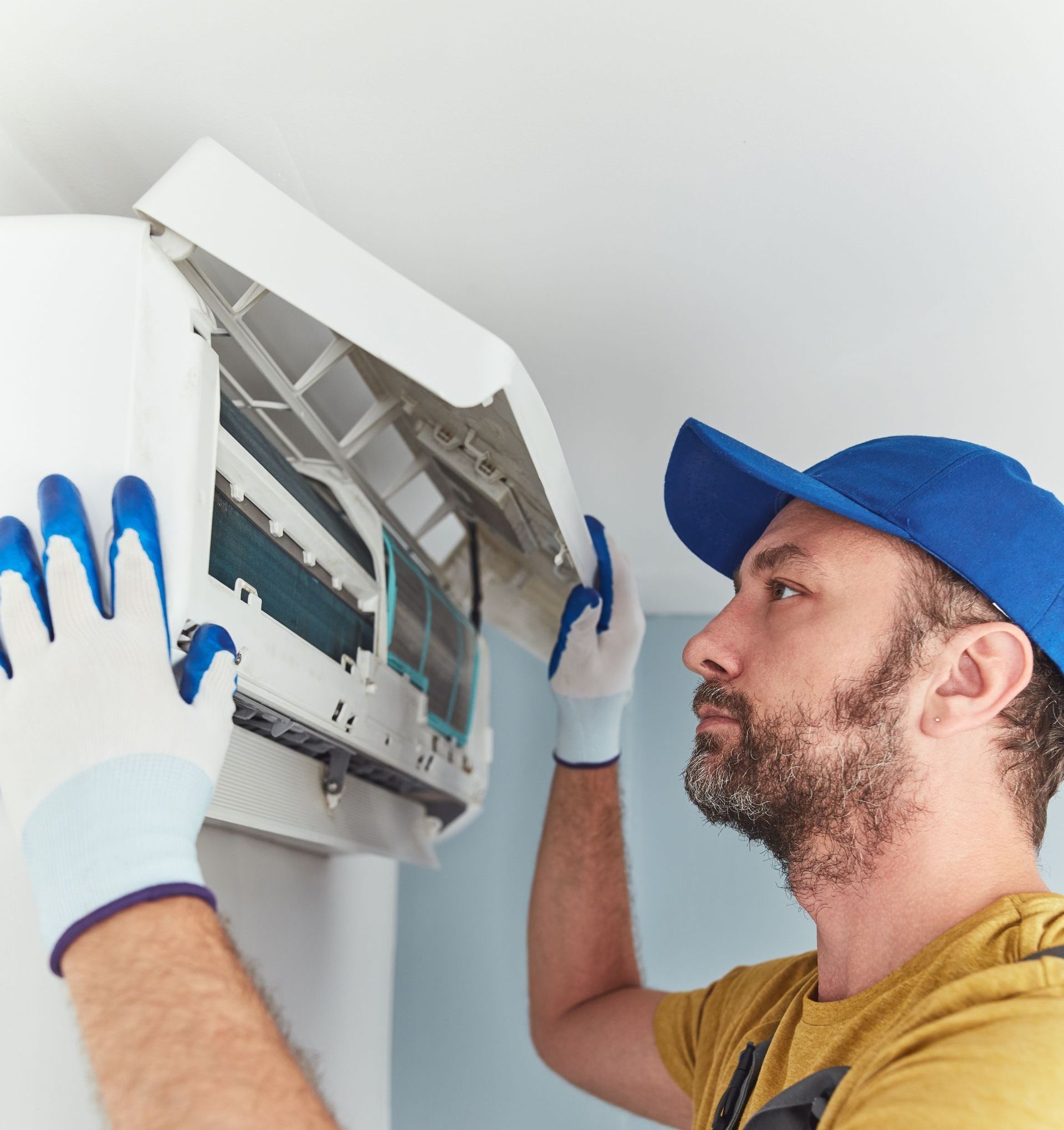 repairman making changeout in existing AC unit