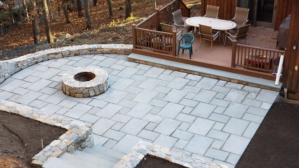 There is a fire pit in the middle of the patio.