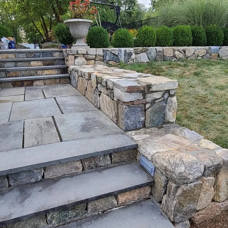 A stone wall with stairs leading up to it