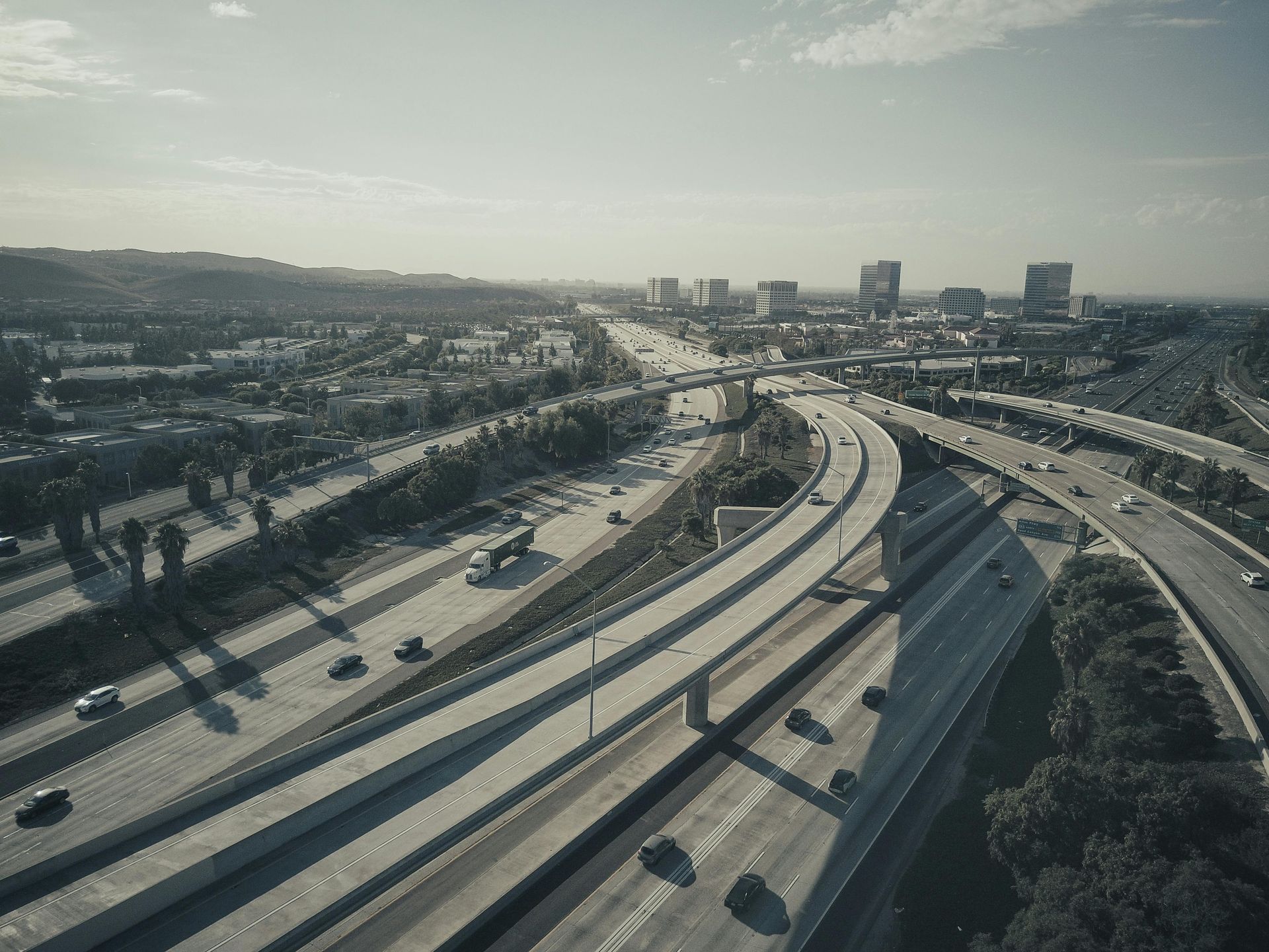 An aerial view of a highway going through a city