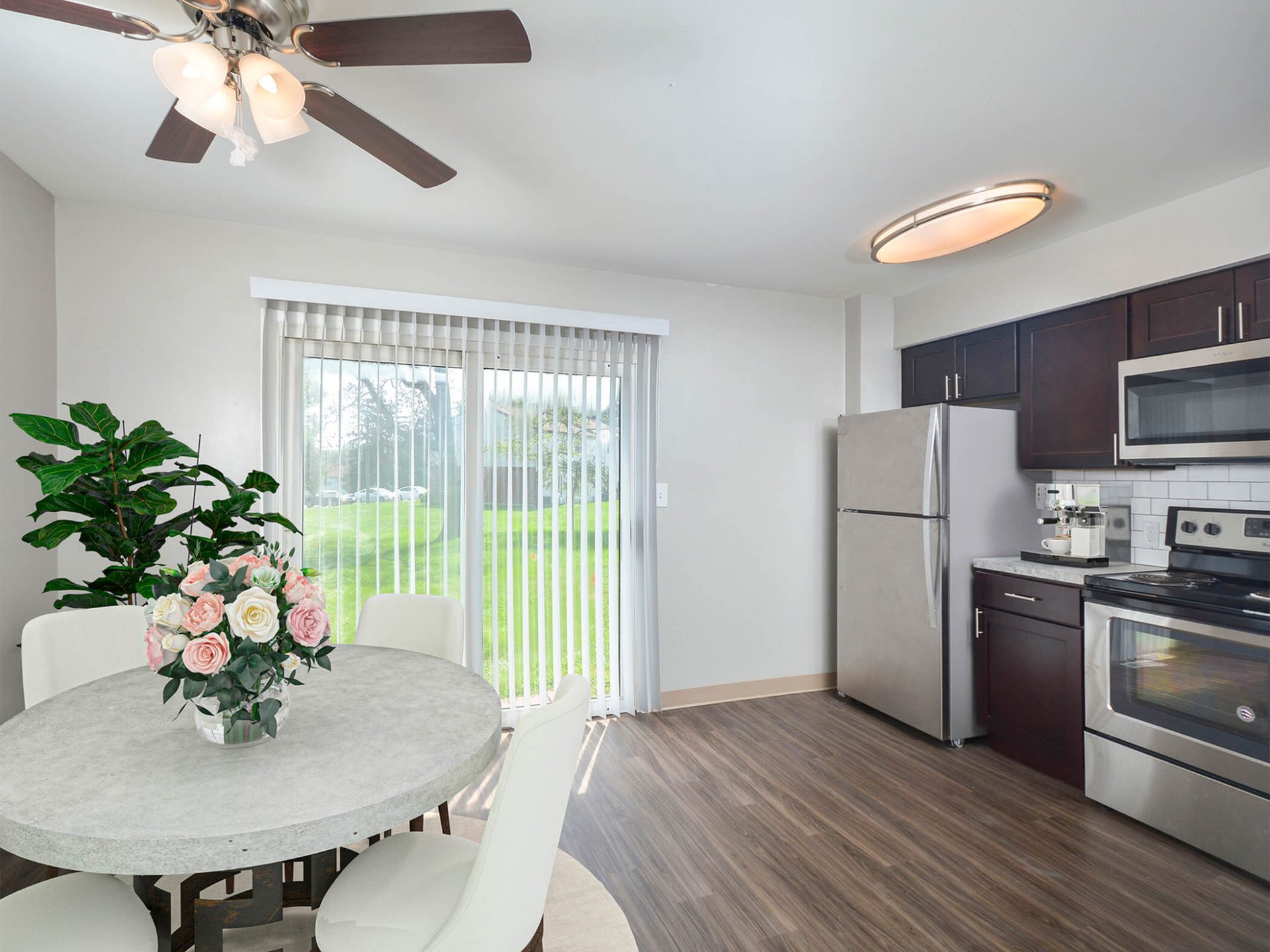 Kitchen and dining area in an apartment with round table, white chairs, dark cabinets, and stainless steel appliances. Contact us today to learn more about our pet-friendly 1, 2, 3, and 4-bedroom apartments for rent in Bethlehem, PA. At River Pointe Townhomes, you’ll enjoy a prime location near Lehigh River and all the amenities and extras that make your life comfortable. We can’t wait to welcome you home!