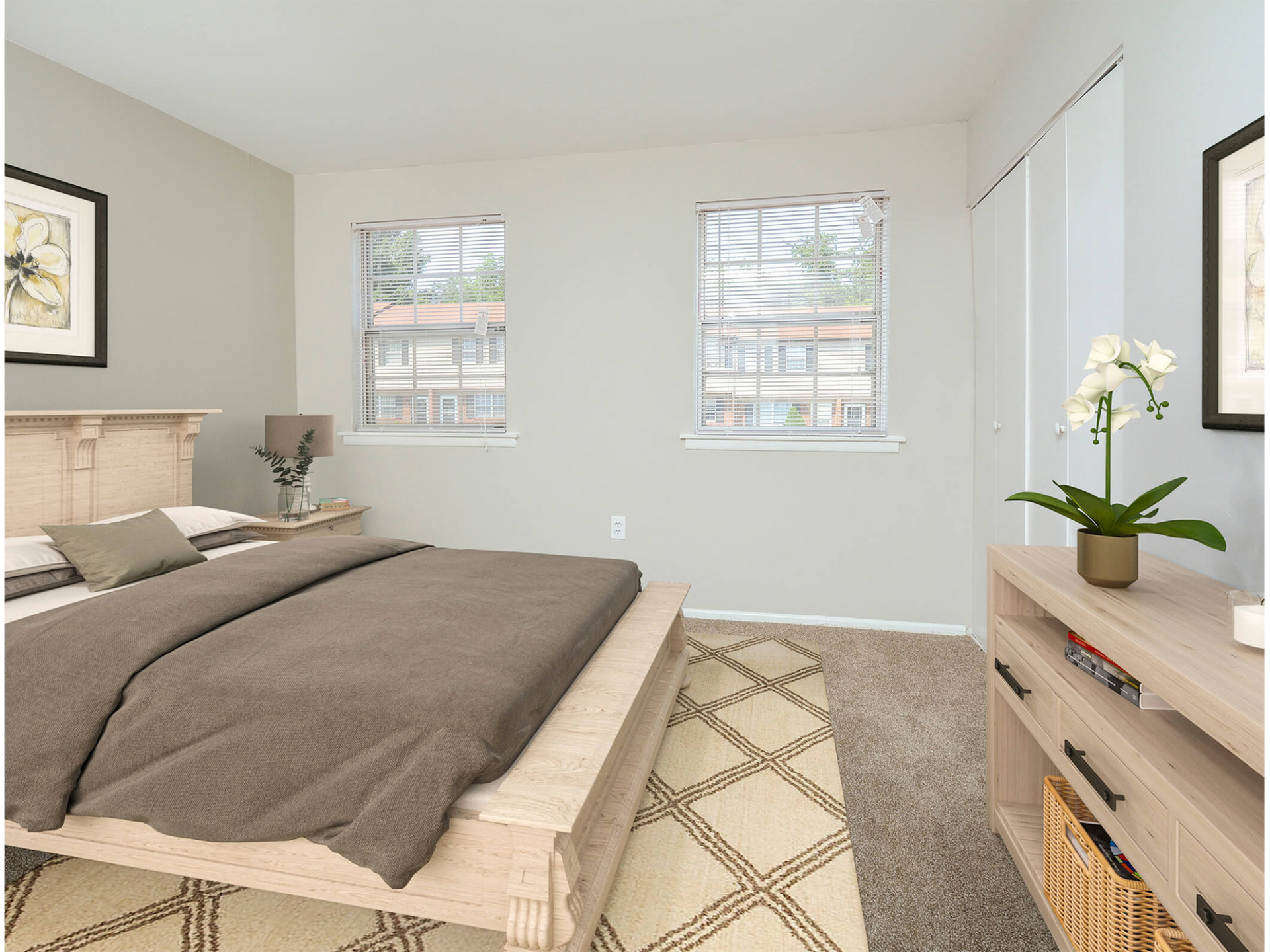 Bedroom in a light-colored apartment with a wooden bed frame, dresser, and two windows. Contact us today to learn more about our pet-friendly 1, 2, 3, and 4-bedroom apartments for rent in Bethlehem, PA. At River Pointe Townhomes, you’ll enjoy a prime location near Lehigh River and all the amenities and extras that make your life comfortable. We can’t wait to welcome you home!