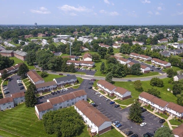Aerial view of a multi-building apartment community with parking lots and green spaces. Contact us today to learn more about our pet-friendly 1, 2, 3, and 4-bedroom apartments for rent in Bethlehem, PA. At River Pointe Townhomes, you’ll enjoy a prime location near Lehigh River and all the amenities and extras that make your life comfortable. We can’t wait to welcome you home!