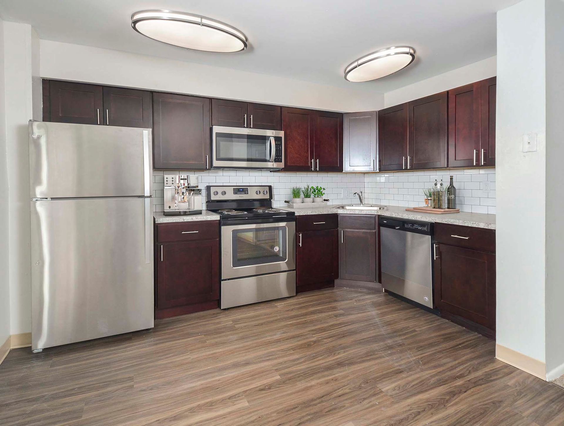 Modern kitchen with dark wood cabinets, stainless-steel appliances, and a white subway tile backsplash. Contact us today to learn more about our pet-friendly 1, 2, 3, and 4-bedroom apartments for rent in Bethlehem, PA. At River Pointe Townhomes, you’ll enjoy a prime location near Lehigh River and all the amenities and extras that make your life comfortable. We can’t wait to welcome you home!