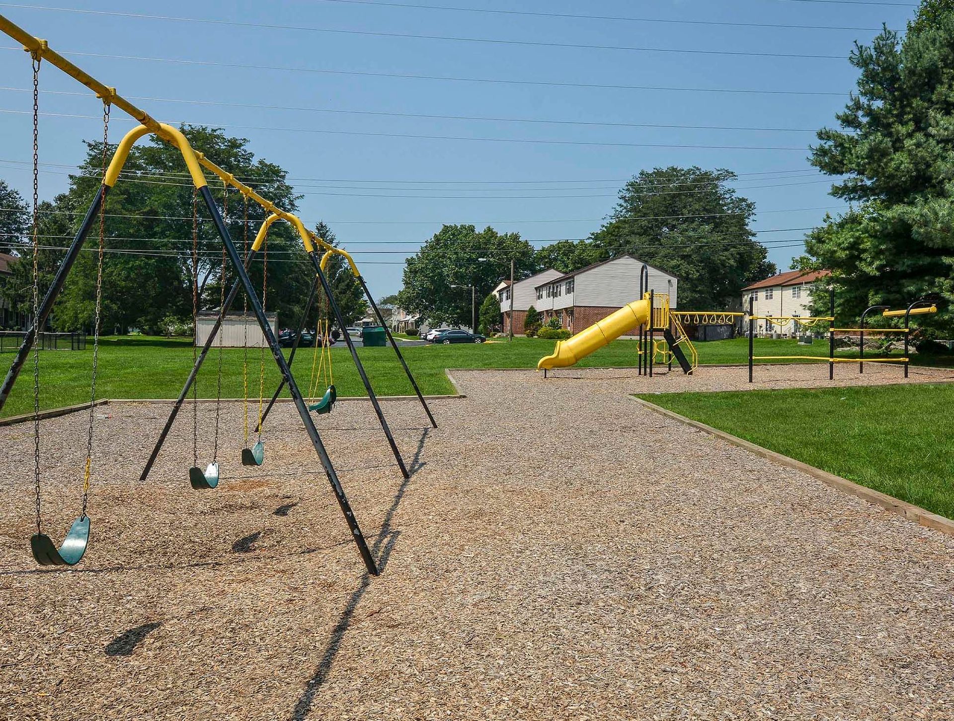 Playground with swings and a yellow slide at a grassy apartment complex. Contact us today to learn more about our pet-friendly 1, 2, 3, and 4-bedroom apartments for rent in Bethlehem, PA. At River Pointe Townhomes, you’ll enjoy a prime location near Lehigh River and all the amenities and extras that make your life comfortable. We can’t wait to welcome you home!