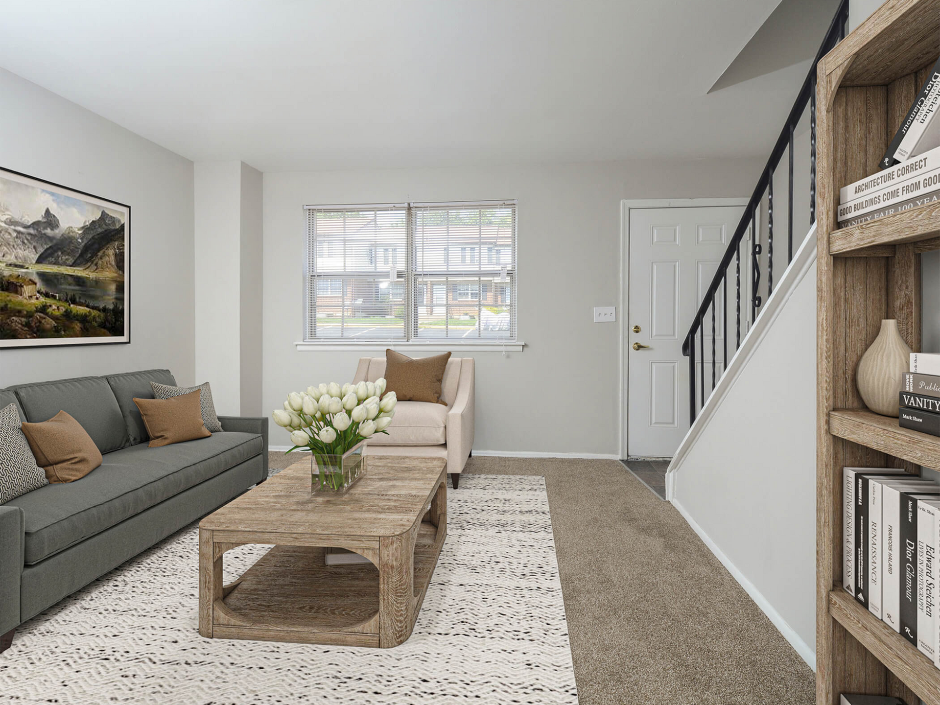 Living room of an apartment with a gray sofa, wood coffee table, and bookshelf by the stairs. Contact us today to learn more about our pet-friendly 1, 2, 3, and 4-bedroom apartments for rent in Bethlehem, PA. At River Pointe Townhomes, you’ll enjoy a prime location near Lehigh River and all the amenities and extras that make your life comfortable. We can’t wait to welcome you home!