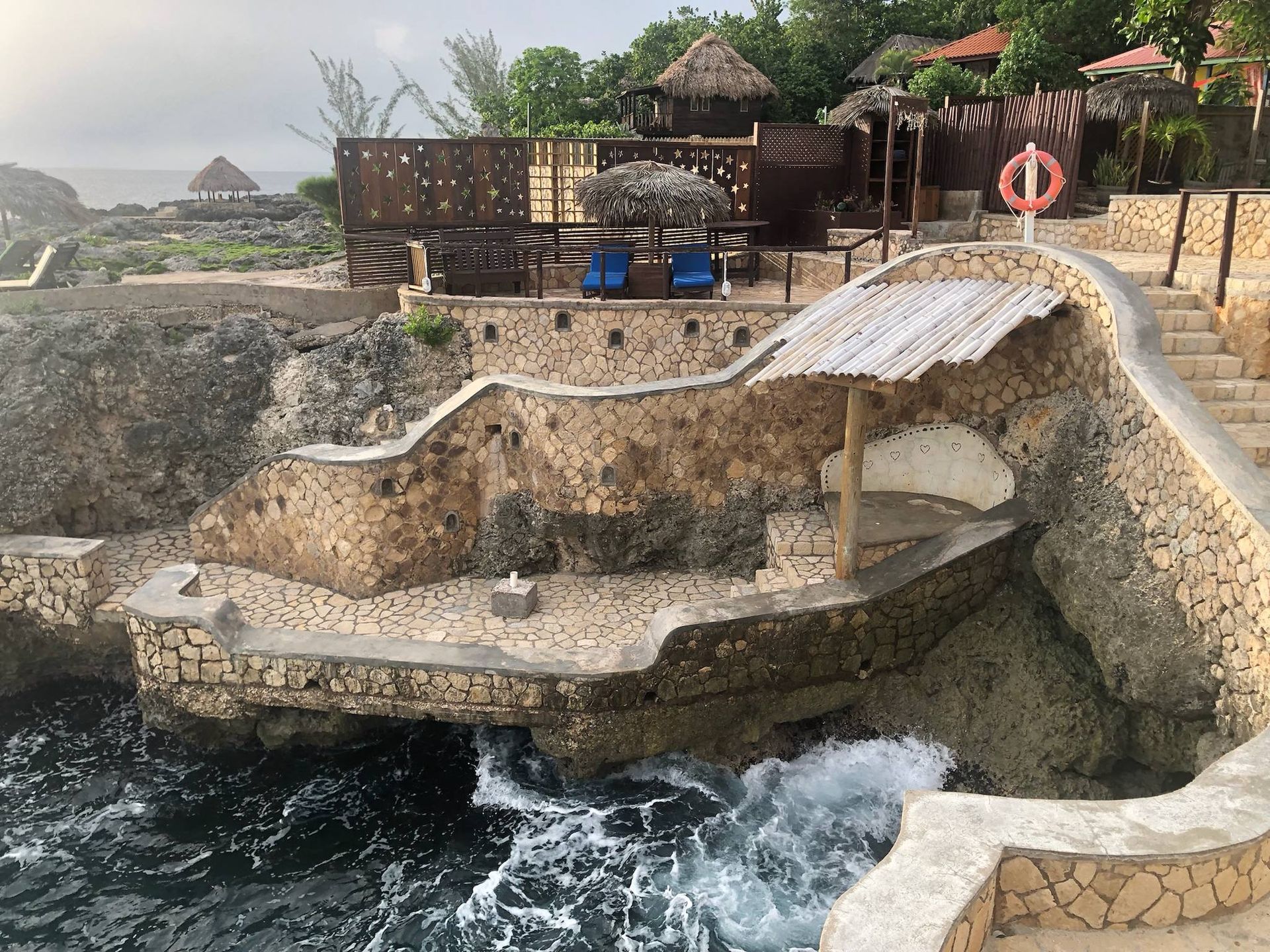 A cliff overlooking the ocean with stairs leading up to it