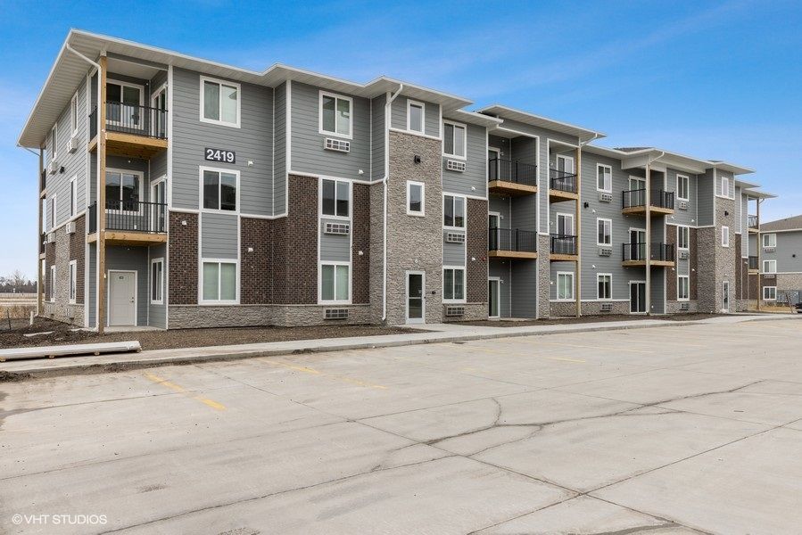A large apartment building with a lot of windows and balconies.