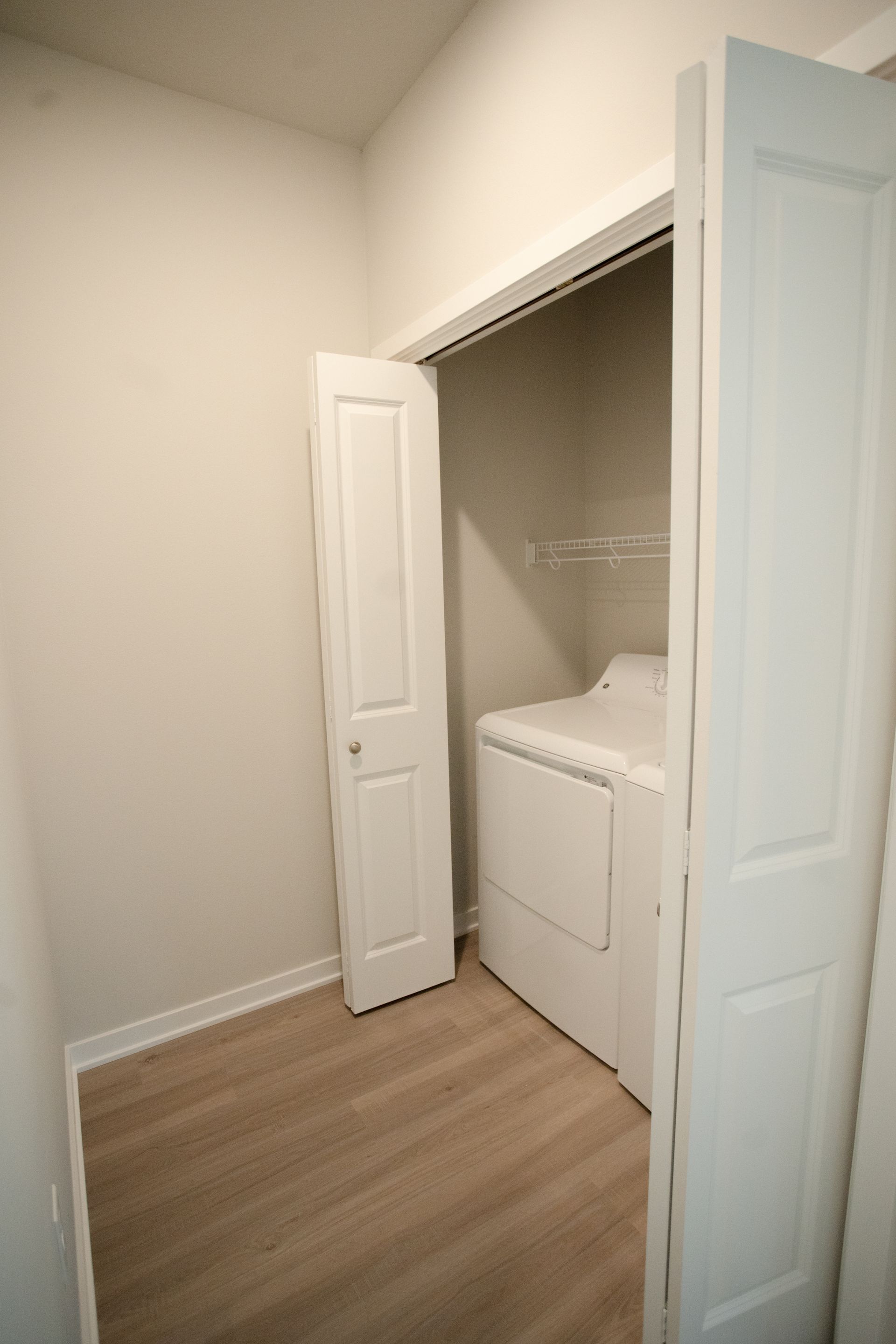 A laundry room with a washer and dryer in a closet.