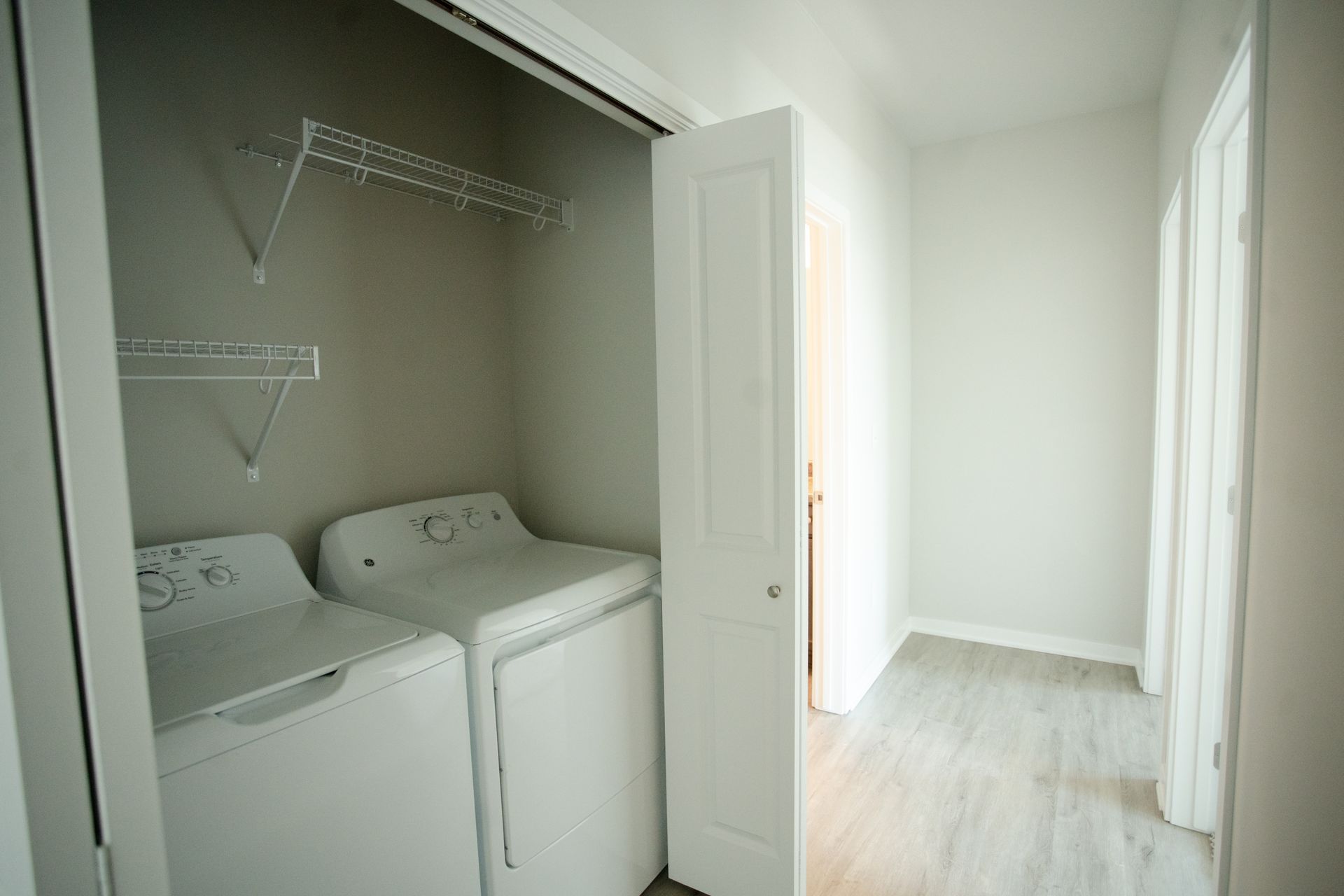 A laundry room with a washer and dryer in a closet.