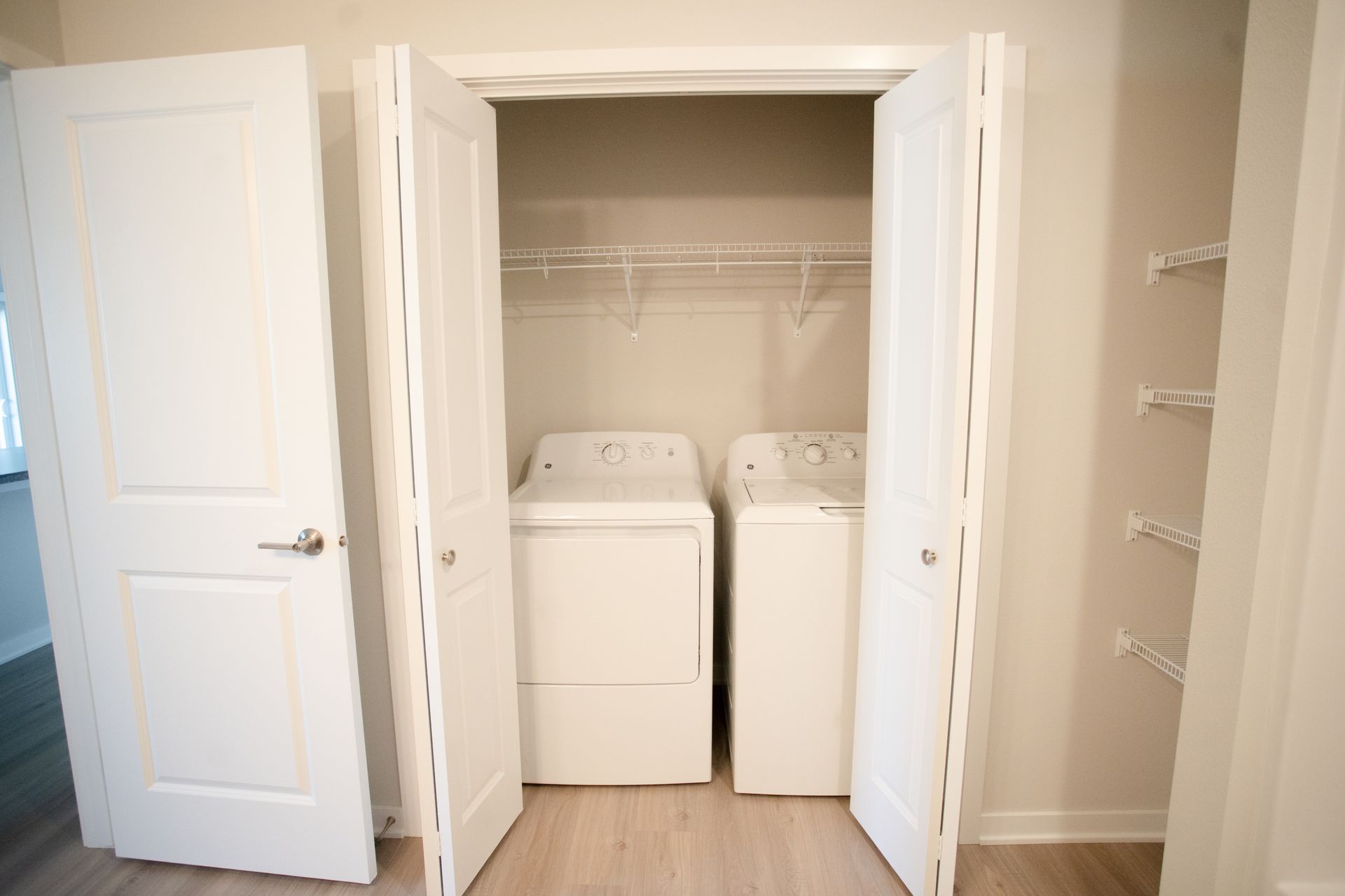 A closet with a washer and dryer in it.