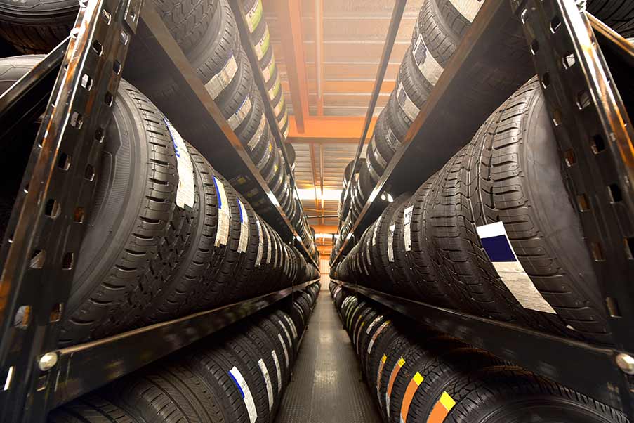 A warehouse filled with lots of tires on shelves