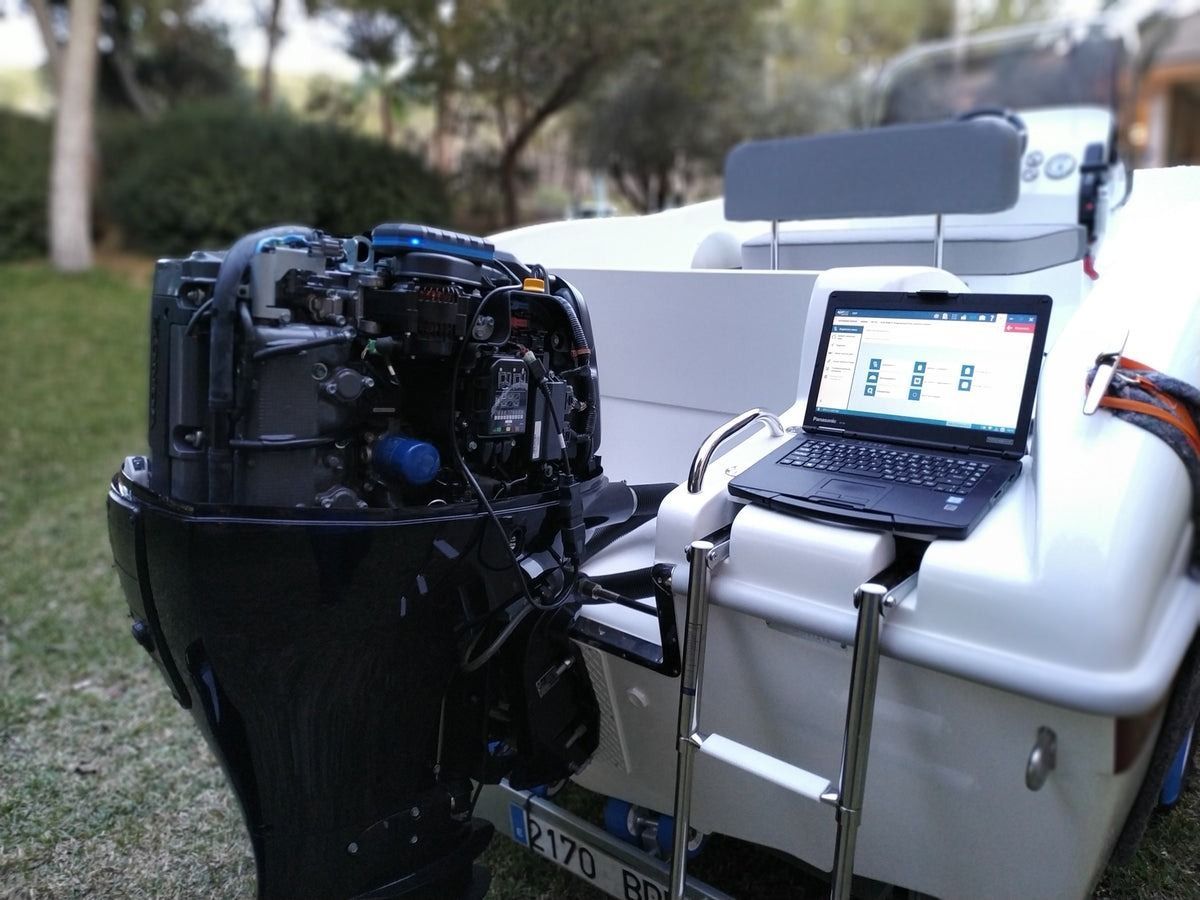 A man in a plaid shirt is using a laptop