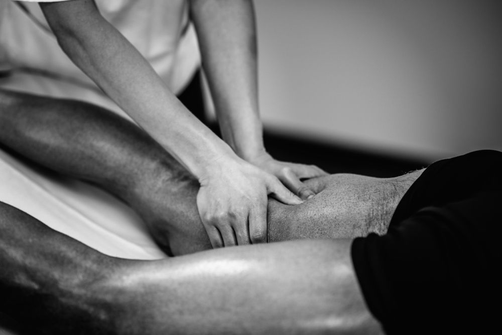 Person Receiving Leg Massage on a Massage Table — A1 Coffs Harbour in Coffs Harbour, NSW