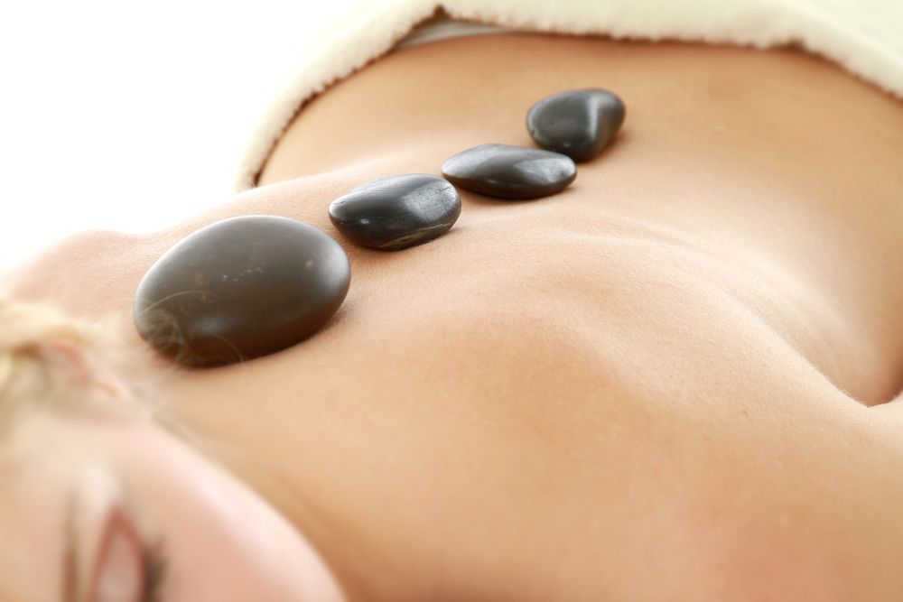 Person Receiving Hot Stone Massage on Their Back — A1 Coffs Harbour in Coffs Harbour, NSW