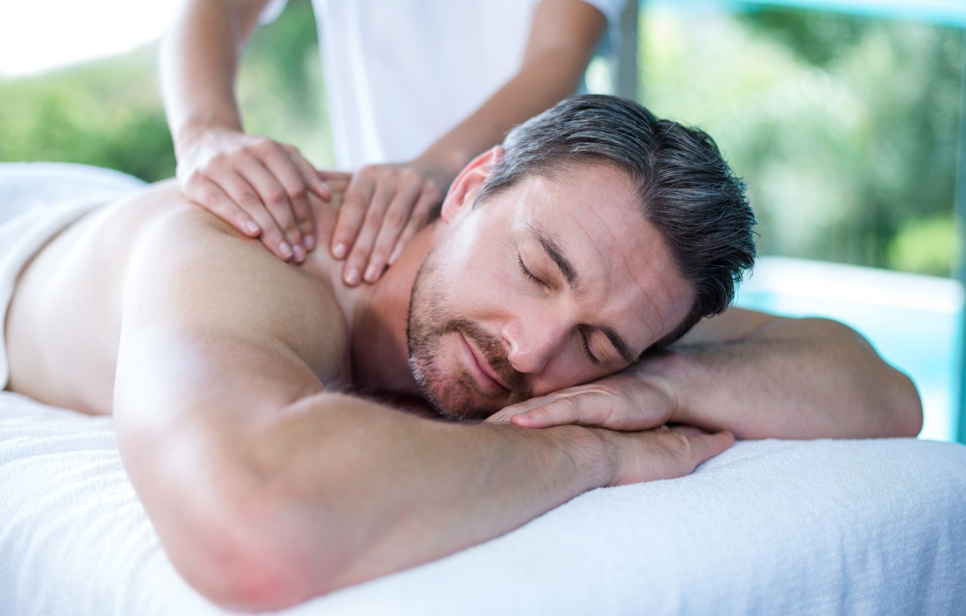Man Receiving a Back Massage in a Spa Setting — A1 Coffs Harbour in Coffs Harbour, NSW