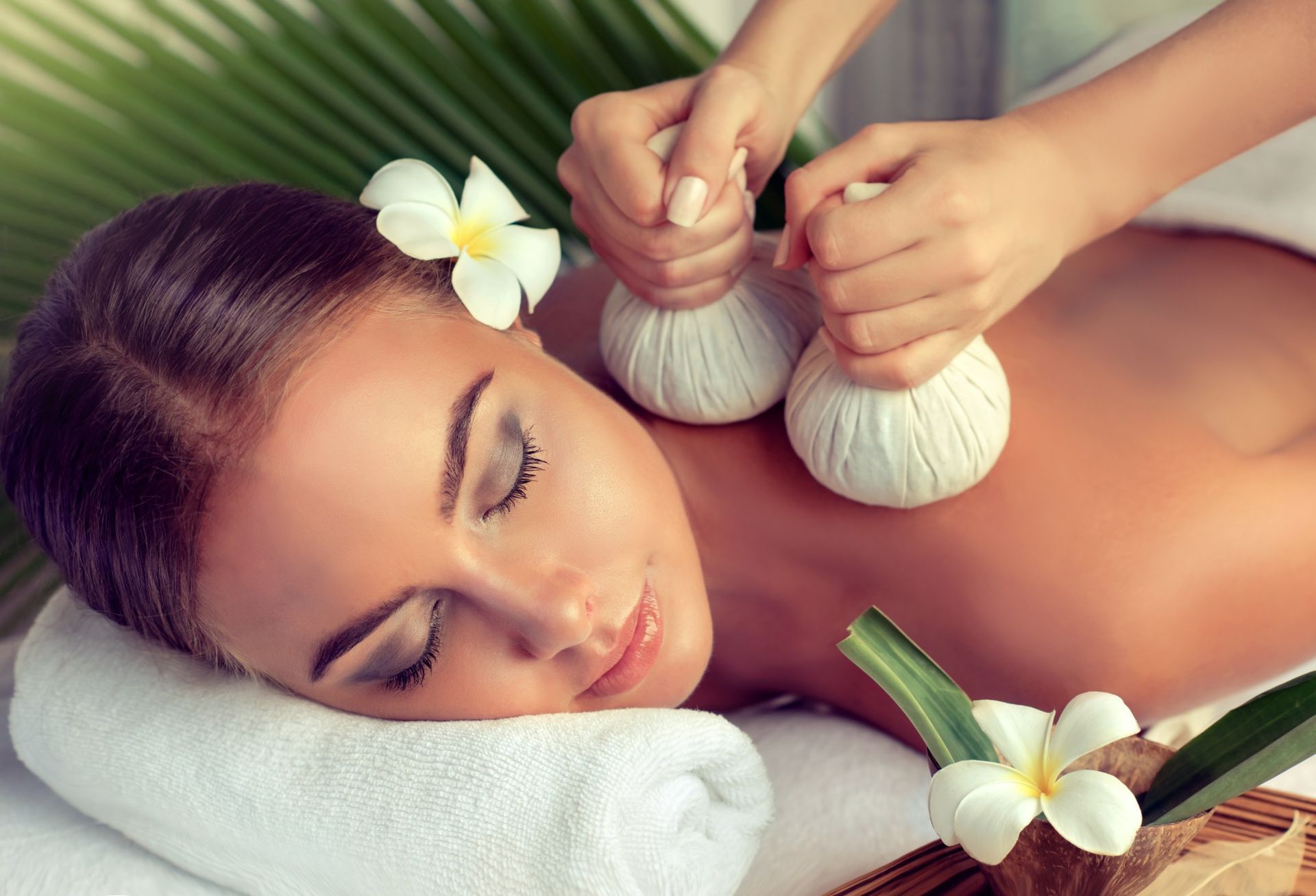 Woman Receiving a Back Massage With Herbal Compress Balls — A1 Coffs Harbour in Coffs Harbour, NSW