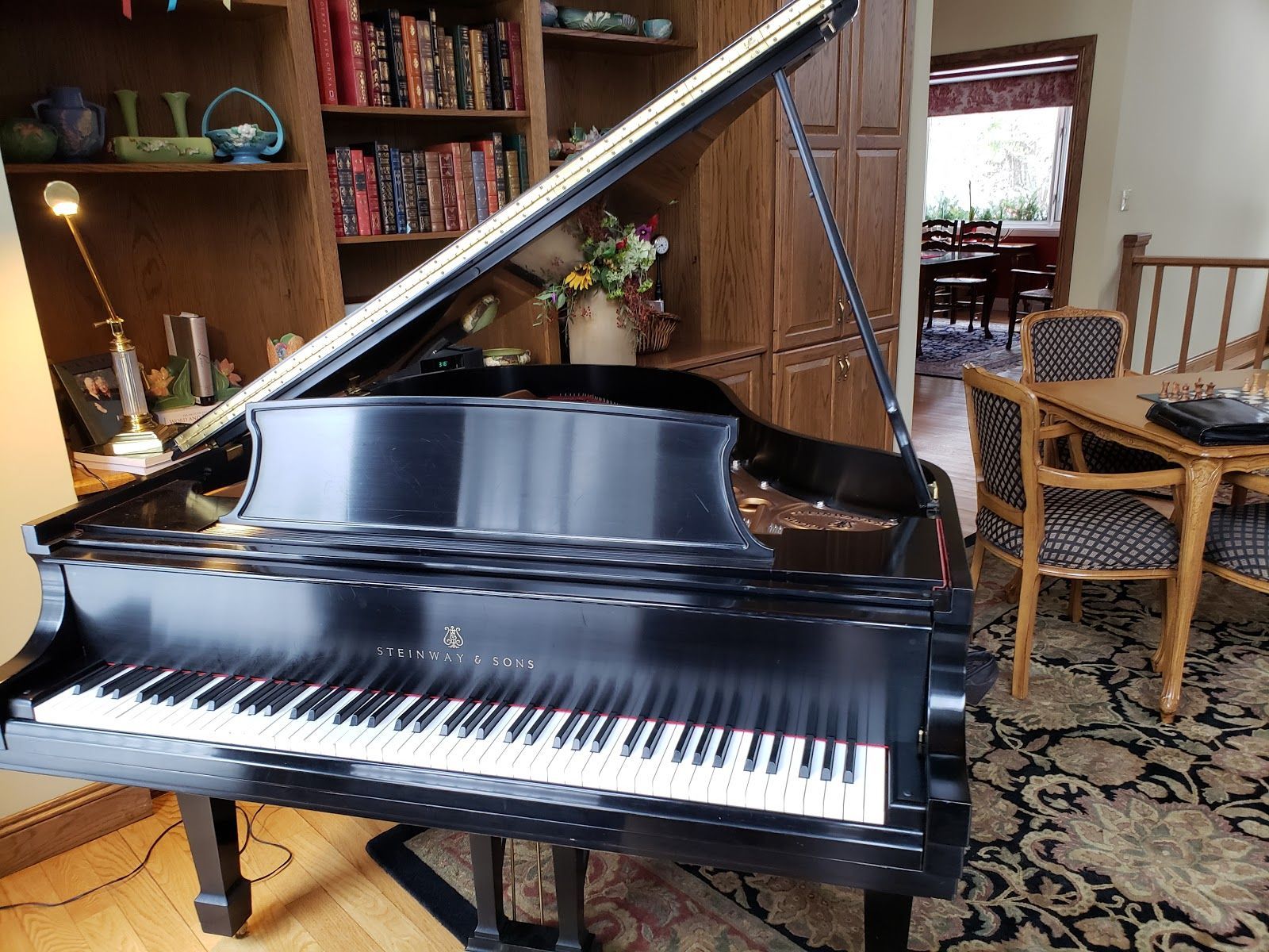 A man wearing a hard hat and goggles is standing in a room.