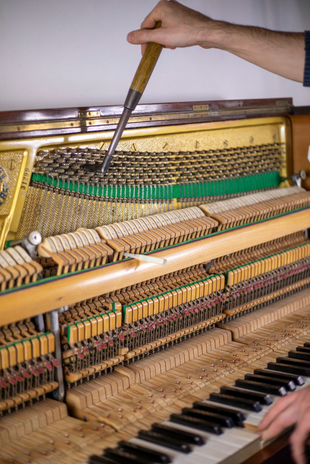A man wearing a hard hat and goggles is standing in a room.