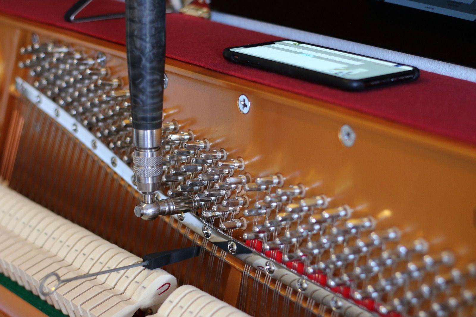 A man wearing a hard hat and goggles is standing in a room.