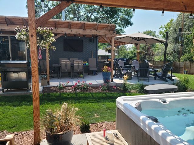 A wooden deck with a couch and chairs on it.