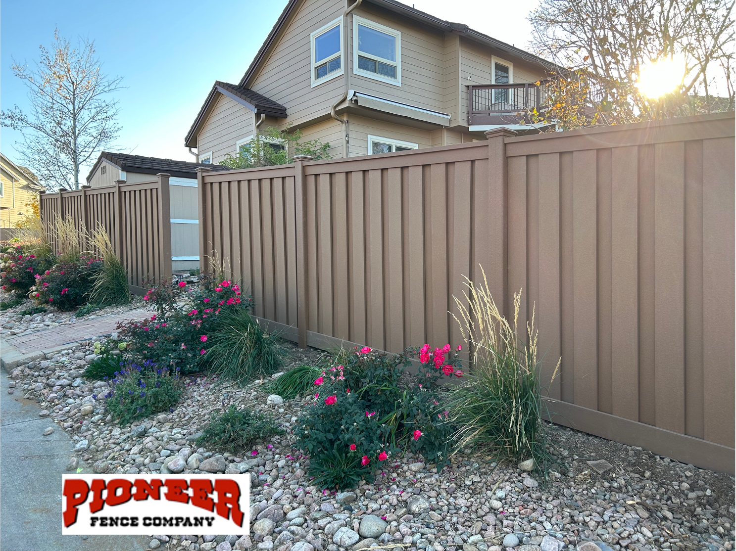 A wooden deck with a lattice fence and stairs leading up to it.