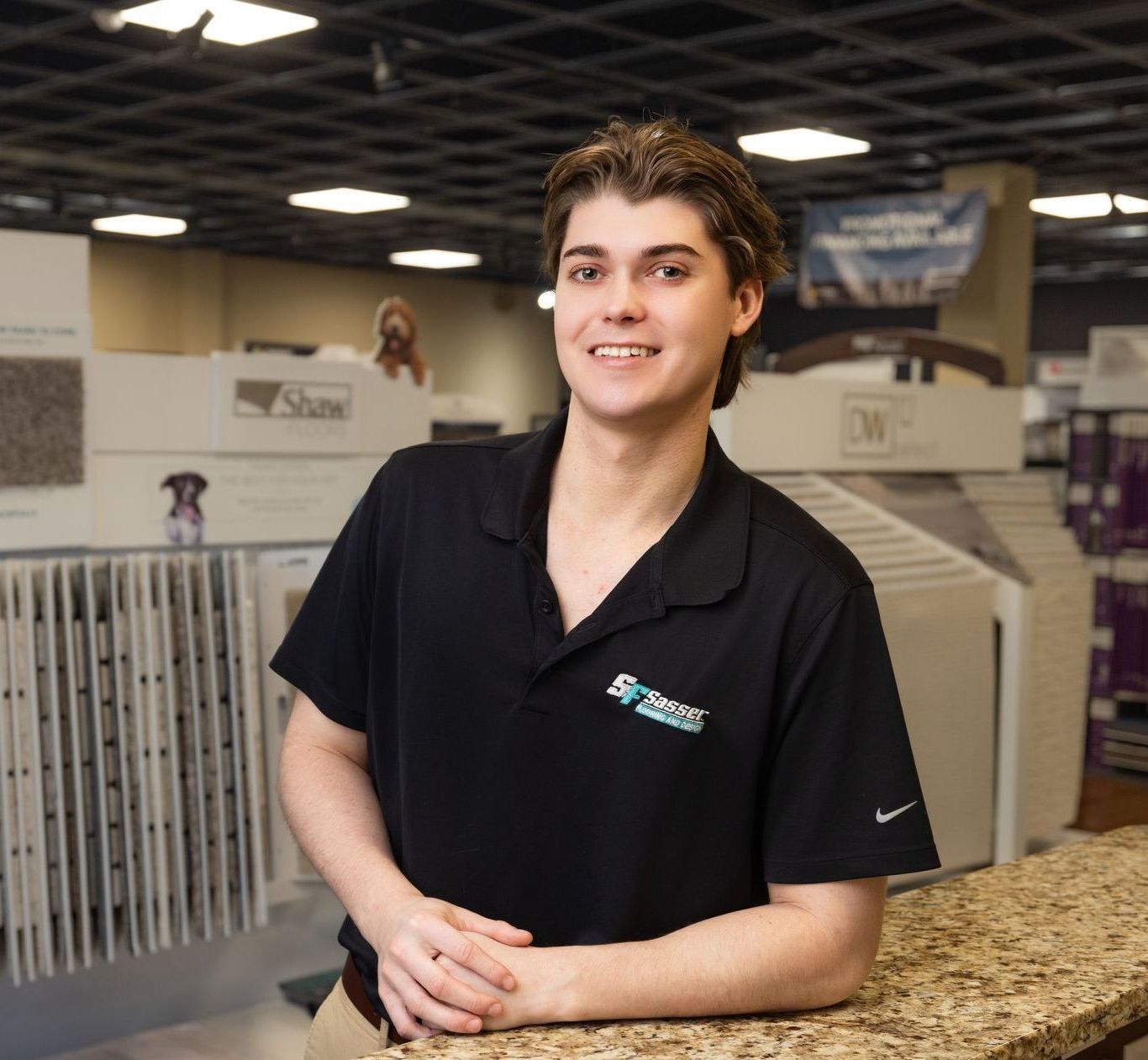 A man wearing a black shirt with the word shine on it