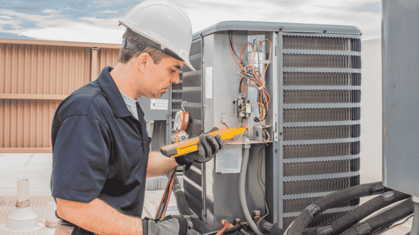 technician gauging a heating unit