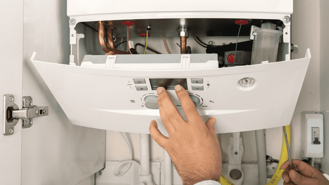 technician opening the panel of a heating control unit