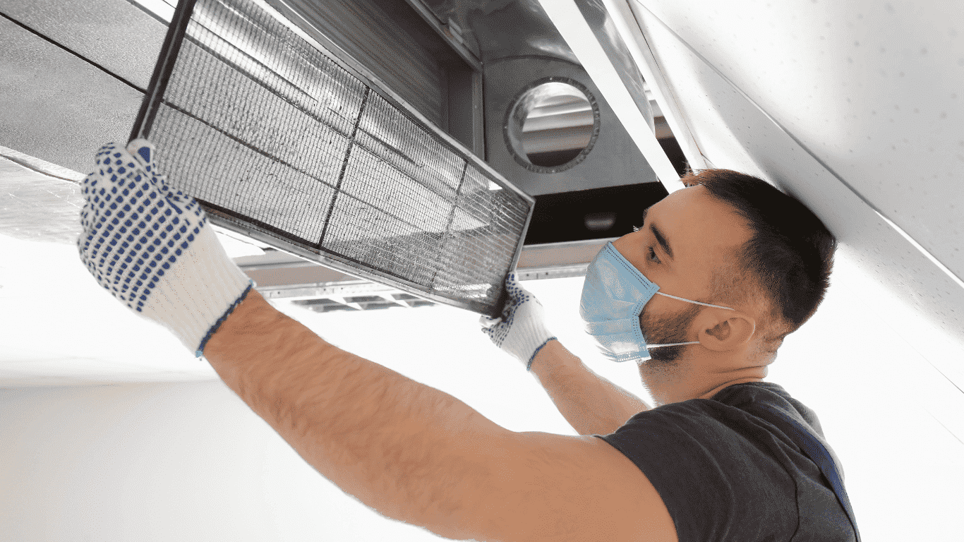 technician cleaning the filter of an air vent