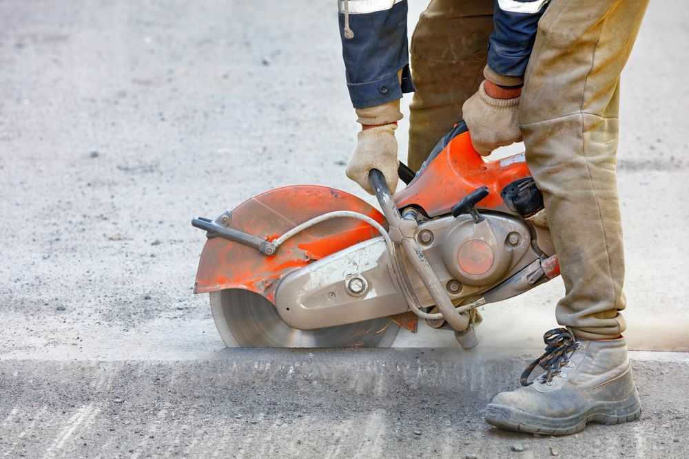 Person Using a Circular Saw to Cut Concrete, Orange Saw — Ultra Services Ground Pavement & Building in Orange, NSW