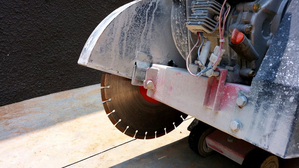 Concrete Saw Cutting Into a Slab, Close-Up of Blade — Ultra Services Ground Pavement & Building in Cowra, NSW