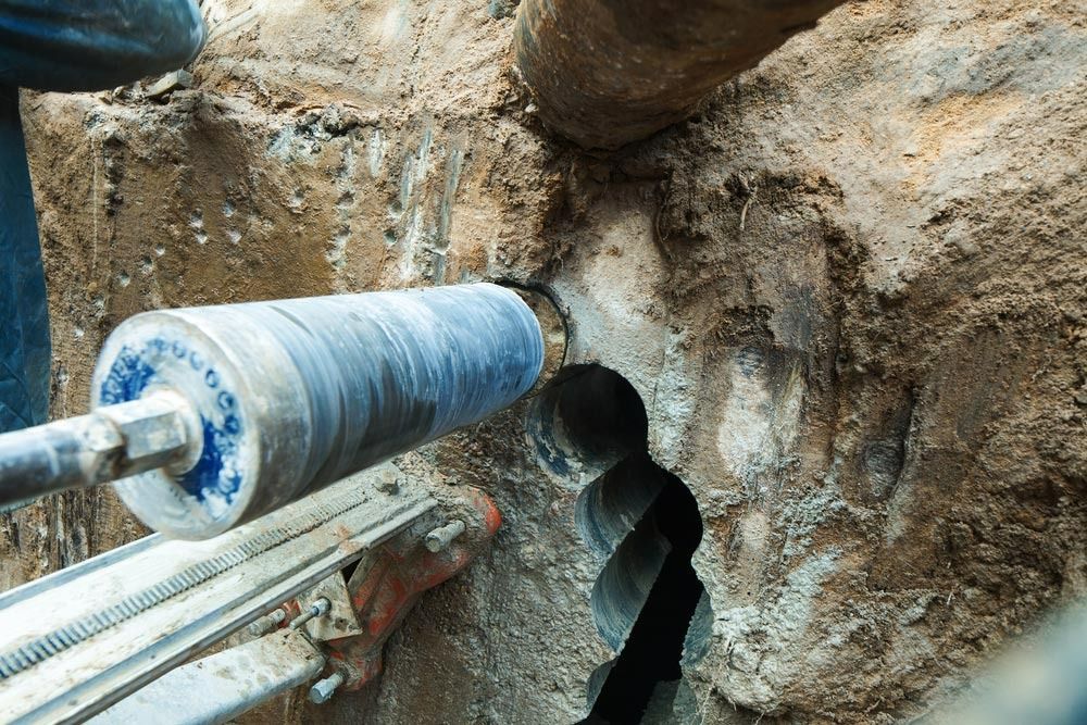 A Core Drill Bores a Hole Through Concrete — Ultra Services Ground Pavement & Building in Abercrombie, NSW