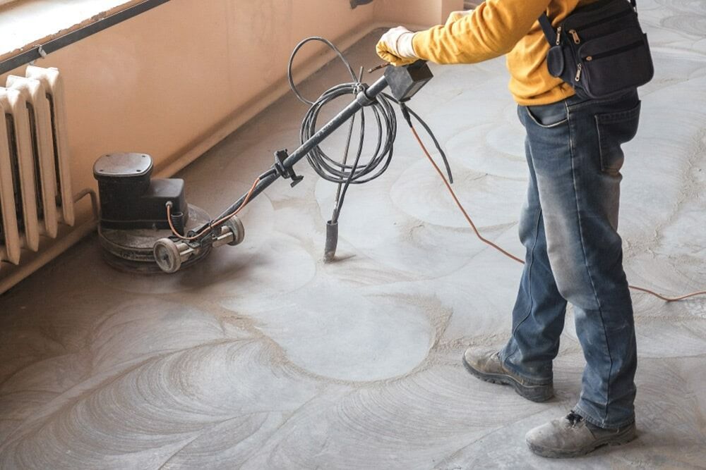 Person Using Floor Buffer on A Concrete Floor Indoors — Ultra Services Ground Pavement & Building in Abercrombie, NSW