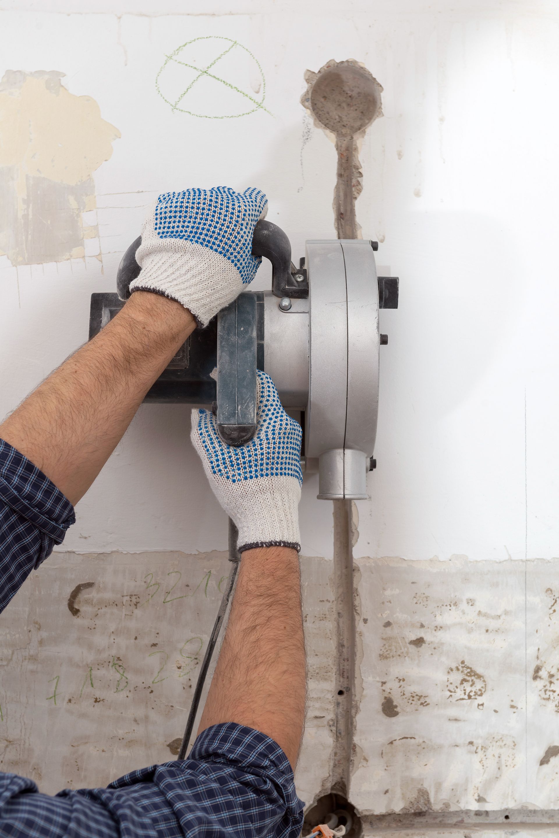 Person Using a Wall Saw to Cut a Line in A White Wall — Ultra Services Ground Pavement & Building in Dubbo, NSW