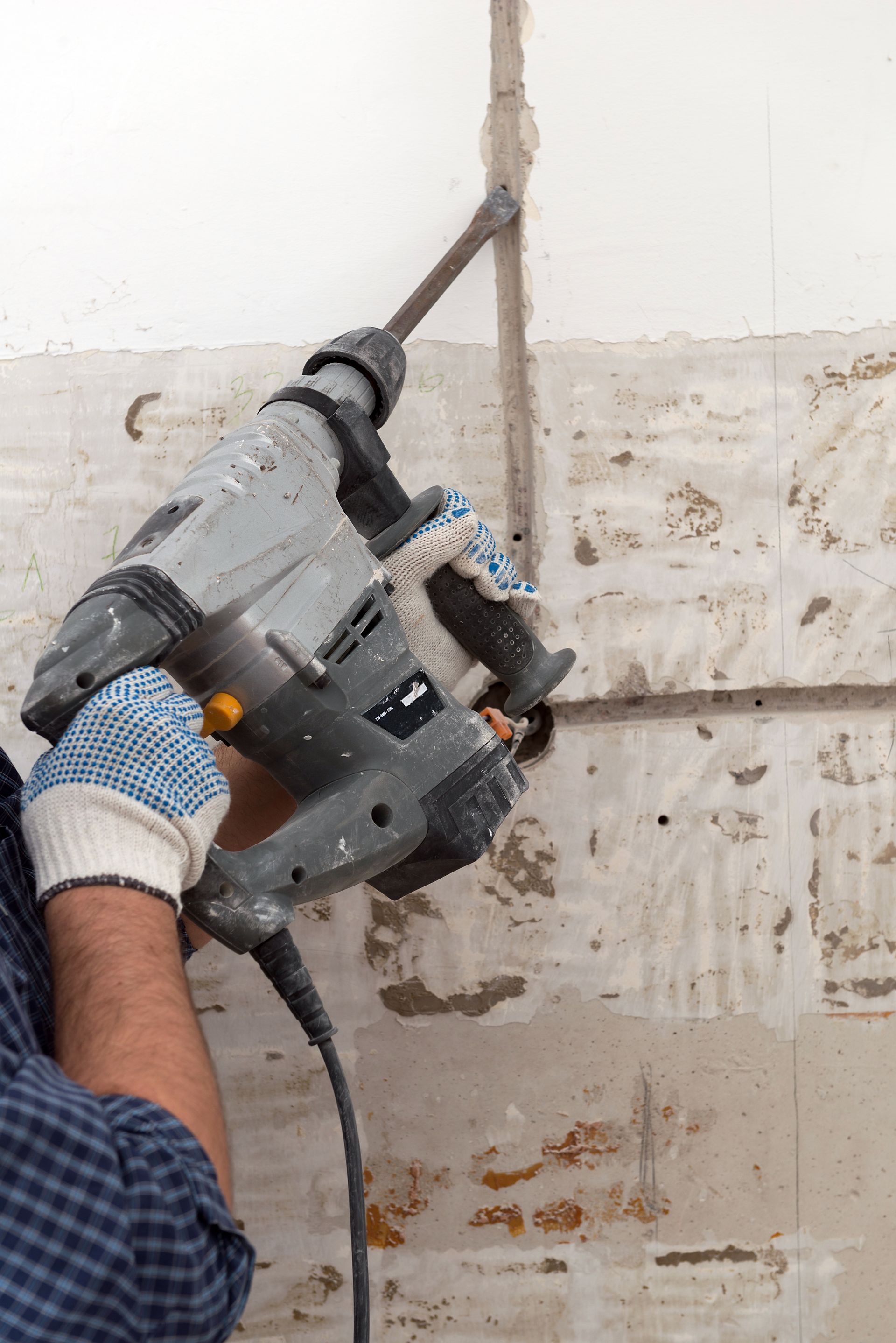 Person Using a Gray Power Drill to Work on A Wall — Ultra Services Ground Pavement & Building in Forbes, NSW