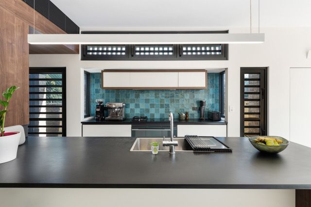 A Kitchen With A Large Island In The Middle Of It — Concept Design Kitchens & Joinery In Forster, NSW