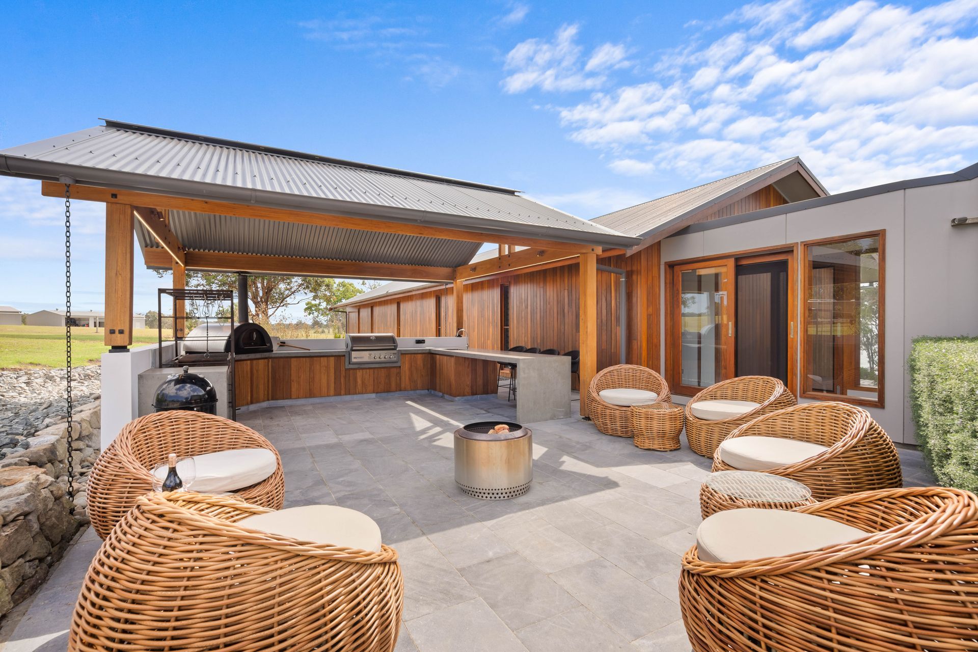 A Kitchen With Wooden Cabinets And A Large Island In The Middle — Concept Design Kitchens & Joinery In Taree, NSW