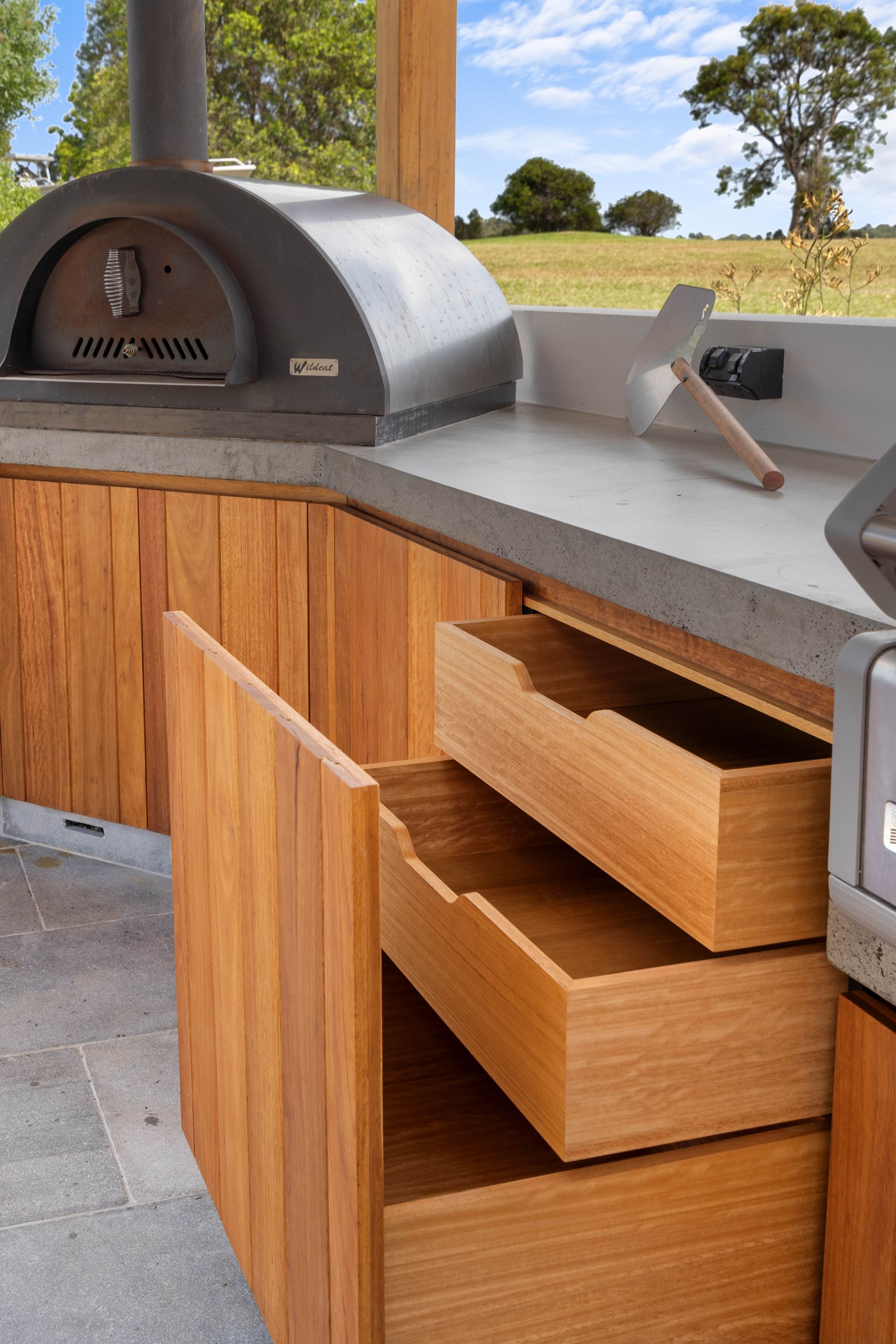 A Kitchen With Stools And A Clock On The Wall — Concept Design Kitchens & Joinery In Taree, NSW