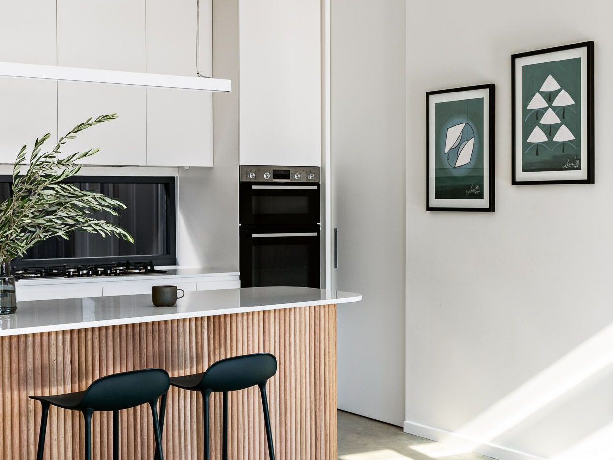 A Kitchen With A Large Island In The Middle Of It — Concept Design Kitchens & Joinery In Taree, NSW 