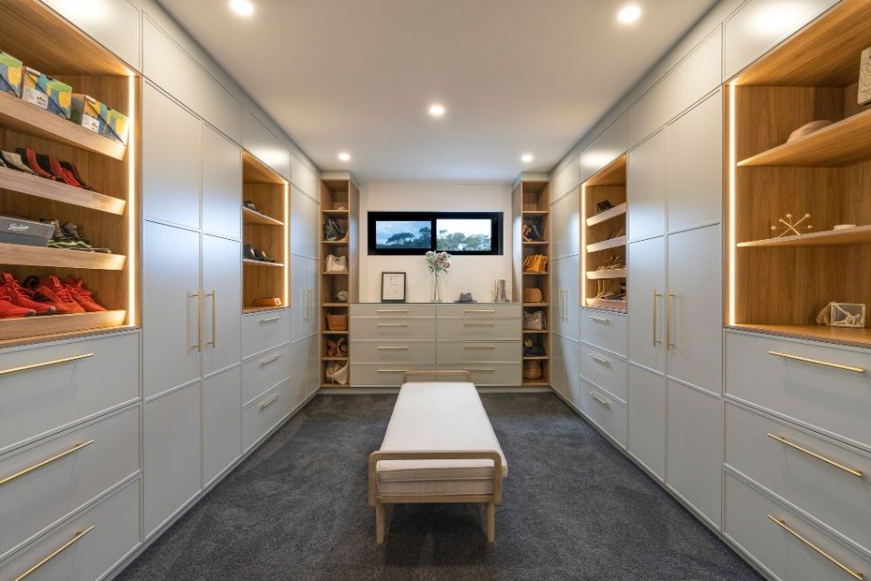 A Walk In Closet With Lots Of Shelves And Drawers And A Bench — Concept Design Kitchens & Joinery In Taree, NSW