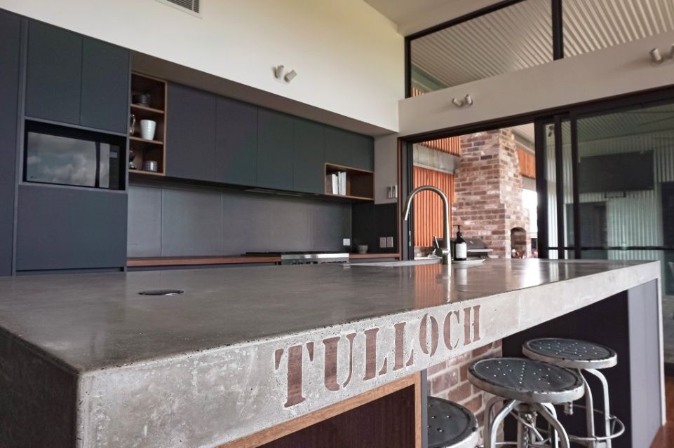 A Kitchen With A Concrete Counter Top That Says Tulloch On It — Concept Design Kitchens & Joinery In Forster, NSW
