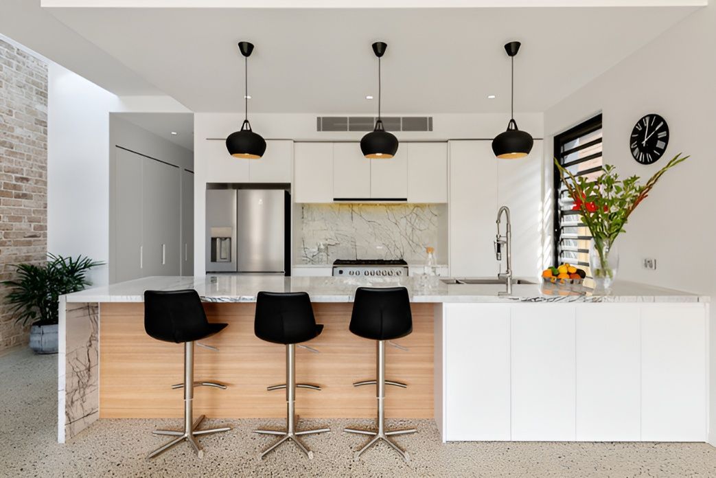 A Kitchen With Stools And A Clock On The Wall — Concept Design Kitchens & Joinery In Taree, NSW