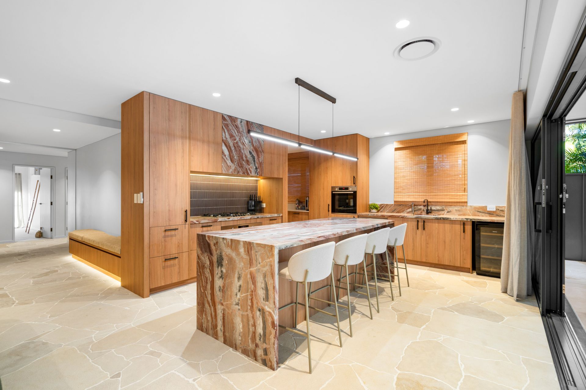 A Kitchen With Stools And A Clock On The Wall — Concept Design Kitchens & Joinery In Taree, NSW