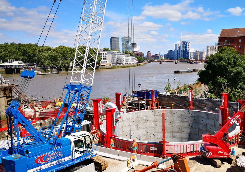 Active Crane Hire machines at work on river side